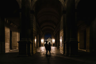 Rear view of man walking in corridor