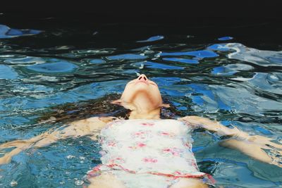 Woman swimming in swimming pool