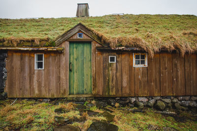 Exterior of house on field against sky