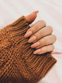 Cropped hand of woman holding sweater
