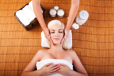 Directly above shot of young woman receiving face massage