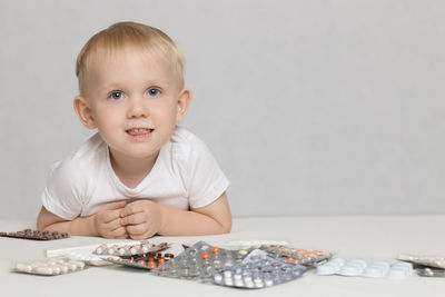 Portrait of cute baby sitting on table