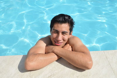 Portrait of young woman swimming in pool