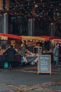 Rear view of people at market stall