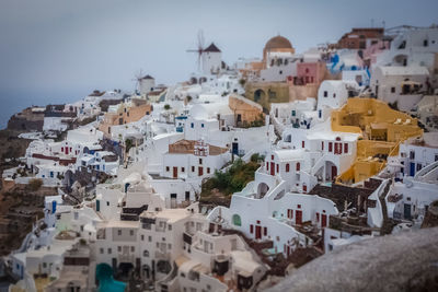 Tilt shirt effect of oia village on a rare rainy day, santorini, greece