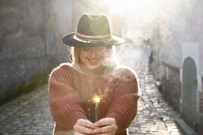 Young woman holding firework