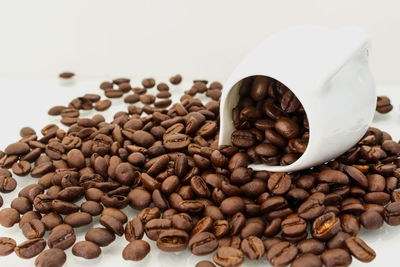 Close-up of coffee beans in container and table 