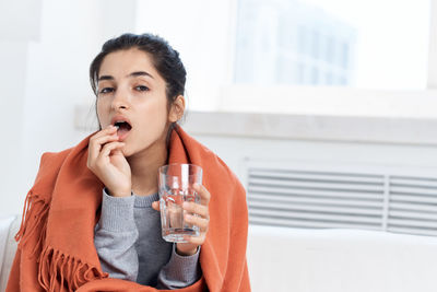 Portrait of a young woman drinking drink