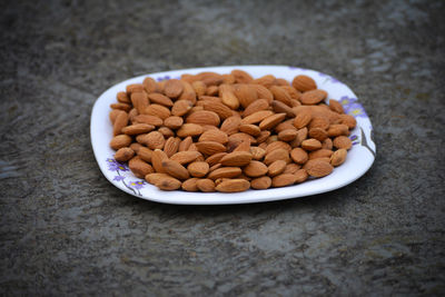 Almonds on a plate. almonds are healthiest nuts and one of the best brain foods.