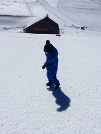 Full length of boy on snowy field during winter