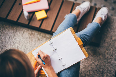 Midsection of woman reading book