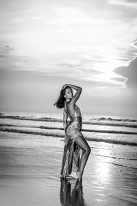 Portrait of young woman standing on beach