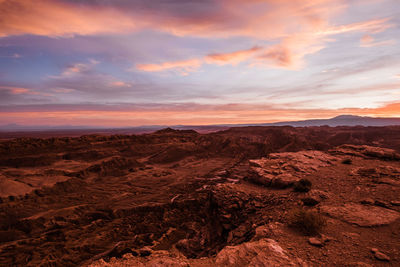 Scenic view of desert against sky during sunset