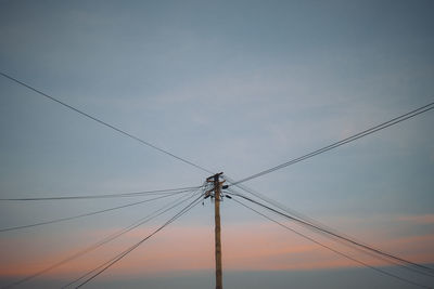 Low angle view of electricity pylon against sky