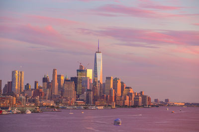 City at waterfront during sunset