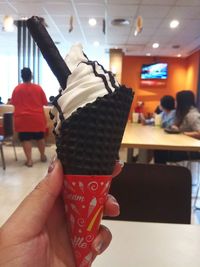 Midsection of man holding ice cream