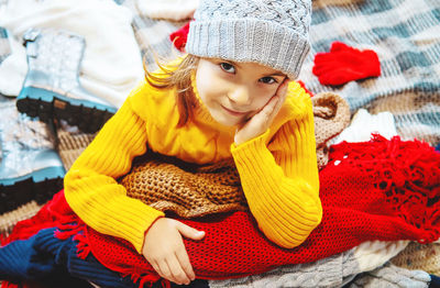 Portrait of girl sitting on sofa at home