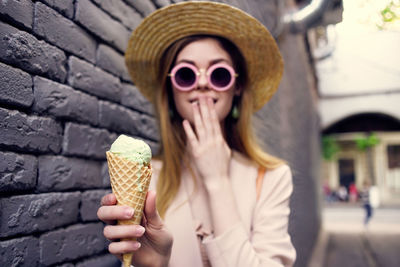 Midsection of woman holding ice cream