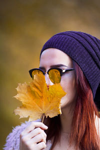 Woman holding dry leaf