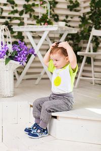 Cute boy sitting outdoors