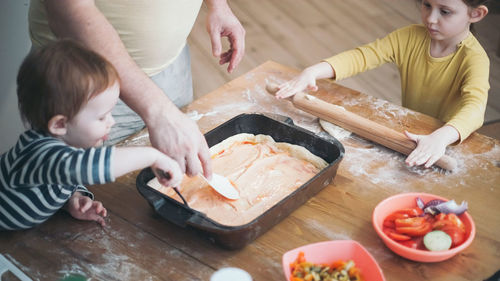 High angle view of mother and son on table