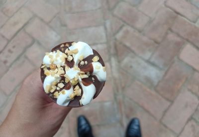 High angle view of hand holding ice cream