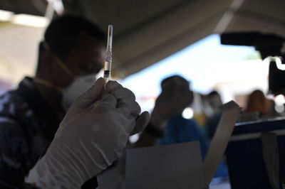 Rear view of people holding mobile phone