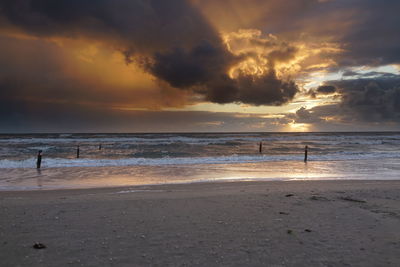 Scenic view of beach against sky during sunset
