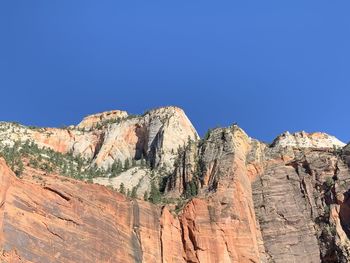 Scenic view of mountain against blue sky