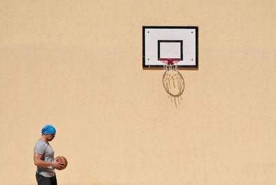 Man standing near basketball hoop