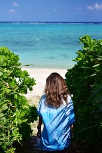 Rear view of woman looking at sea against sky