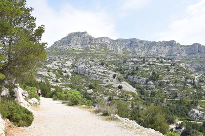 Rear view of people walking on mountain road