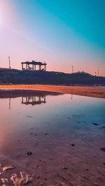 Scenic view of beach against sky during sunset