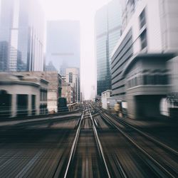 Blurred view of railroad track passing through downtown district