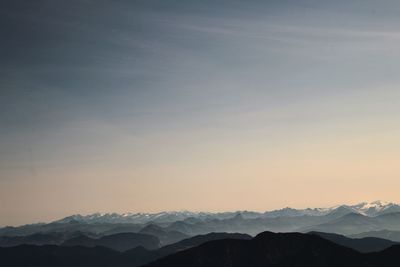 Scenic view of snowcapped mountains against sky during sunset