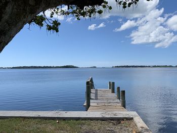 Pier over lake against sky