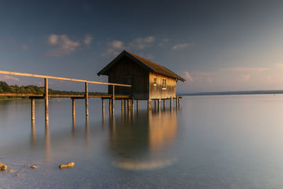 Scenic view of lake by building against sky