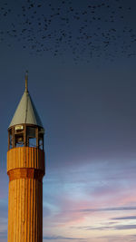 Low angle view of lighthouse against sky during sunset