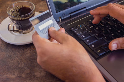 High angle view of person using laptop on table