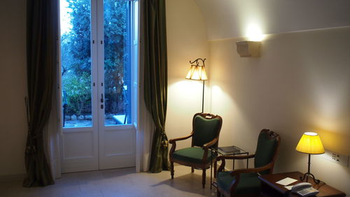 Empty chairs and table against wall at home