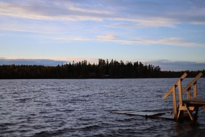 Scenic view of lake against sky at sunset