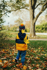 Full length of boy on field during autumn