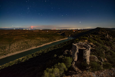 Scenic view of landscape against sky at night