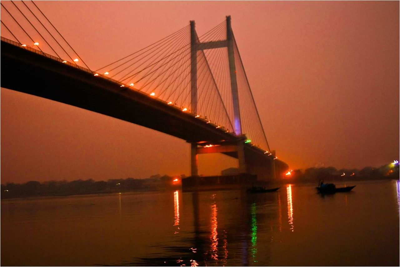 water, bridge, transportation, bridge - man made structure, connection, sky, built structure, engineering, architecture, suspension bridge, sunset, river, nature, travel destinations, tourism, travel, orange color, waterfront, outdoors, bay, long