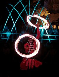 Midsection of woman with illuminated lighting equipment at night