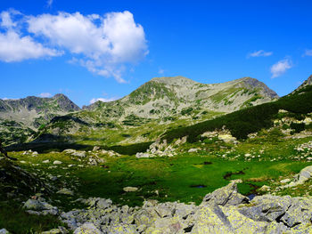 Scenic view of mountains against blue sky