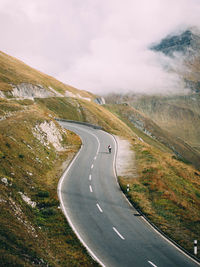 Road amidst field against sky