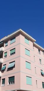 Low angle view of building against clear blue sky