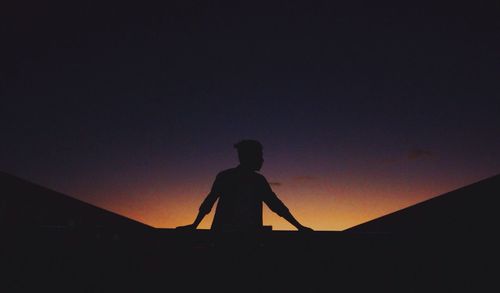 Silhouette of man against sky during sunset