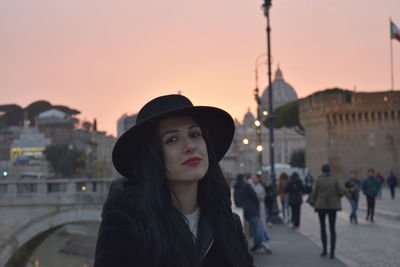 Portrait of woman standing against sky during sunset